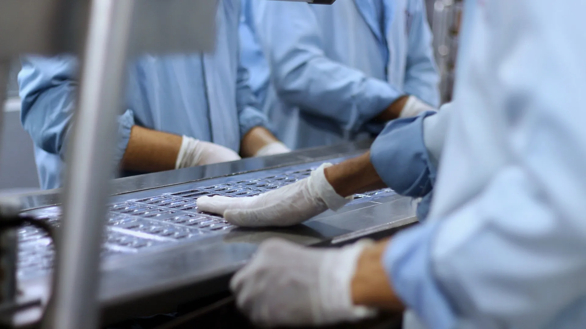 Workers on a pharmaceutical production line.